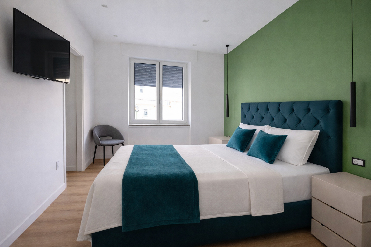 Camera Olga - letto e parete verde
